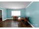 Dining room with hardwood floors, blue walls, table, chairs and plenty of natural light at 7016 Tirzah Rd, Waxhaw, NC 28173