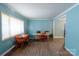 Dining room with hardwood floors, blue walls, table, chairs, and large window at 7016 Tirzah Rd, Waxhaw, NC 28173