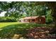 Brick home featuring a well-manicured lawn and mature trees at 7016 Tirzah Rd, Waxhaw, NC 28173