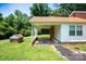 Home exterior with covered parking area and separate brick storage unit at 7016 Tirzah Rd, Waxhaw, NC 28173