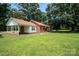 Charming red brick home featuring a covered porch and sprawling green lawn at 7016 Tirzah Rd, Waxhaw, NC 28173
