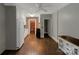 Kitchen featuring white cabinets, brick accent wall, and hardwood floors at 7016 Tirzah Rd, Waxhaw, NC 28173