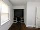 Bright office space with built in shelving and desk, neutral walls, and a large bright window at 7016 Tirzah Rd, Waxhaw, NC 28173