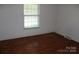 Bedroom with hardwood floors, natural light, and neutral wall color at 7017 Knightswood Dr, Charlotte, NC 28226