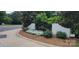 Well-maintained community entrance sign with lush greenery and floral accents at 7017 Knightswood Dr, Charlotte, NC 28226