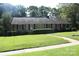 Inviting brick home with well-kept lawn, offering classic charm and appealing outdoor space at 7017 Knightswood Dr, Charlotte, NC 28226