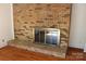 Living area featuring a brick fireplace with metallic enclosure and hardwood flooring at 7017 Knightswood Dr, Charlotte, NC 28226