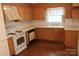 Functional kitchen with laminate countertops, wooden cabinets and white appliances at 7017 Knightswood Dr, Charlotte, NC 28226