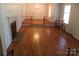 Spacious living room featuring hardwood floors, fireplace, staircase and ample natural light at 7017 Knightswood Dr, Charlotte, NC 28226