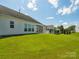 Expansive backyard featuring lush green lawn and a screened porch, perfect for outdoor activities at 8036 Crater Lake Dr, Fort Mill, SC 29707
