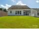 Well-maintained backyard with manicured lawn, screened porch, and privacy fencing, offering a serene outdoor space at 8036 Crater Lake Dr, Fort Mill, SC 29707