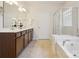 Bright bathroom with double vanity, soaking tub and walk-in shower at 8036 Crater Lake Dr, Fort Mill, SC 29707