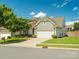 Charming home featuring a well-manicured lawn, mature trees, and a two-car garage at 8036 Crater Lake Dr, Fort Mill, SC 29707