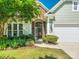 Close up view of the front entrance with stone accents and well landscaped garden beds enhancing the curb appeal at 8036 Crater Lake Dr, Fort Mill, SC 29707