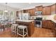 Kitchen with a center island and bar stools perfect for casual dining, stainless steel appliances and granite counters at 8036 Crater Lake Dr, Fort Mill, SC 29707