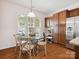 Bright eat-in kitchen features a glass table and wood cabinets with stainless steel appliances at 8036 Crater Lake Dr, Fort Mill, SC 29707