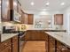 Stylish kitchen with granite counters, wood cabinets, stainless steel appliances, and bar window at 8036 Crater Lake Dr, Fort Mill, SC 29707