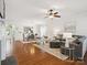 Open-concept living room with hardwood floors flowing into the dining area, perfect for entertaining at 8036 Crater Lake Dr, Fort Mill, SC 29707