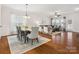 Spacious living room and dining area with hardwood floors, lots of windows and neutral-toned furniture creating a cozy living space at 8036 Crater Lake Dr, Fort Mill, SC 29707