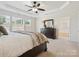 Comfortable bedroom with plush carpet and a doorway to the ensuite bathroom and walk-in closet at 8036 Crater Lake Dr, Fort Mill, SC 29707