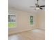 Bright bedroom with hardwood floors, ceiling fan, and large windows offering a view of the outdoors at 903 Brookdale St, Kannapolis, NC 28083