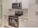 Updated kitchen showcasing stainless steel appliances, sleek granite countertops and stylish white cabinetry at 903 Brookdale St, Kannapolis, NC 28083