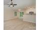 Open-concept living space featuring hardwood floors, ceiling fan and sliding glass doors to backyard at 903 Brookdale St, Kannapolis, NC 28083