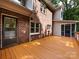 View of the back deck with brickwork and screened-in porch for outdoor relaxation and entertainment at 9415 Braemar Ter, Charlotte, NC 28210