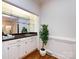 A stylish home bar features ample counter space and mirrored shelving at 9415 Braemar Ter, Charlotte, NC 28210