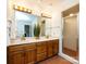 Bathroom featuring a double vanity with a full mirror, hexagon tile and a glass-enclosed shower at 9415 Braemar Ter, Charlotte, NC 28210
