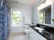 Bathroom with blue patterned shower curtain, a granite countertop, and a window with outside views at 9415 Braemar Ter, Charlotte, NC 28210