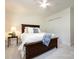 Bedroom with neutral walls, plush carpet, ceiling fan, and a double-door closet for storage at 9415 Braemar Ter, Charlotte, NC 28210
