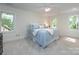 Bedroom featuring neutral walls, plush carpet, ceiling fan and a large window with outdoor views at 9415 Braemar Ter, Charlotte, NC 28210