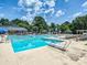 Large community pool with clear blue water, surrounded by lounge chairs and lush greenery at 9415 Braemar Ter, Charlotte, NC 28210