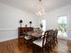 Elegant dining room featuring hardwood floors, a chandelier, and ample natural light at 9415 Braemar Ter, Charlotte, NC 28210
