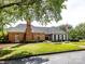 Beautiful exterior view of a brick and gray home, showcasing its well-manicured lawn and curb appeal at 9415 Braemar Ter, Charlotte, NC 28210