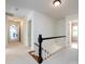 Upstairs hallway featuring neutral walls and carpet with access to bedrooms and office at 9415 Braemar Ter, Charlotte, NC 28210