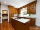 Charming kitchen features light countertops, a center island, and wooden cabinetry at 9415 Braemar Ter, Charlotte, NC 28210