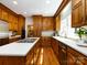Eat-in kitchen with stainless appliances, center island cooktop, and wood cabinets at 9415 Braemar Ter, Charlotte, NC 28210