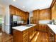 Well-equipped kitchen features a center island cooktop, and abundant wood cabinets at 9415 Braemar Ter, Charlotte, NC 28210