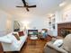 Comfortable living area with fireplace, built-in shelving, and hardwood floors at 9415 Braemar Ter, Charlotte, NC 28210