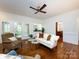 Spacious living room features hardwood floors, access to the outdoor patio, and a wet bar at 9415 Braemar Ter, Charlotte, NC 28210