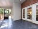 Screened porch with blue tile flooring, wood ceilings, and views of an outdoor deck at 9415 Braemar Ter, Charlotte, NC 28210