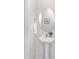 Elegant powder room featuring a pedestal sink, oval mirror, and minimalist design, perfect for guests at 1043 20Th Avenue Se Loop, Hickory, NC 28602