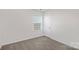 Bedroom with neutral walls, carpet, a window, and a closet door at 1043 20Th Avenue Se Loop, Hickory, NC 28602