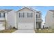 Charming two-story home featuring a two-car garage and gray siding, perfect for modern living at 1043 20Th Avenue Se Loop, Hickory, NC 28602