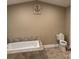 Bathroom featuring a soaking tub, toilet and tile flooring at 110 Indian Harbor Cir, Mount Gilead, NC 27306