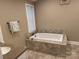 Bright bathroom featuring a soaking tub and a vanity at 110 Indian Harbor Cir, Mount Gilead, NC 27306