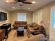 Comfortable living room with ceiling fan, sofa, loveseat, and media center at 110 Indian Harbor Cir, Mount Gilead, NC 27306