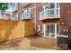 Fenced backyard showing the patio with sliding glass doors and brick exterior at 1125 Kurt Ct, Charlotte, NC 28209